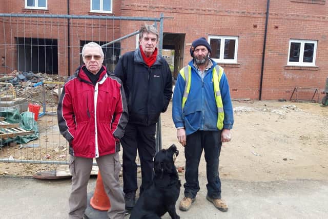 L-R: Maurice Kiff, Cllr Phil Sawford and Harvey Smith outside the new houses which consultants failed to realise are being built. It's proposed that electric vehicle charging points are installed right outside the driveways.