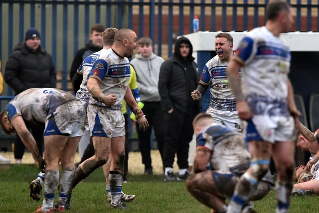 Danny Holmes (left) and Calum Butler (right) celebrate on the final whistle while teammates are exhausted by their efforts in the 18-10 victory over Thatto Heath. Picture: MATTHEW MERRICK