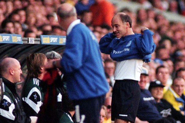 Referee David Ellery goes over to the Leeds United dugout to swap his shirt.