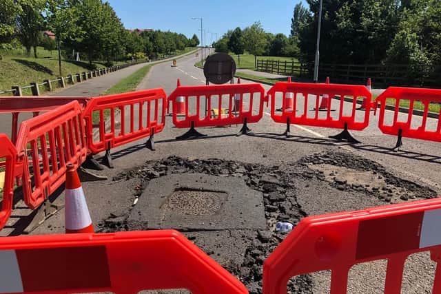 The storm caused the whole surface of the road to lift away