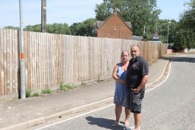 Rebecca and Simon with the fence that they have been told has to go