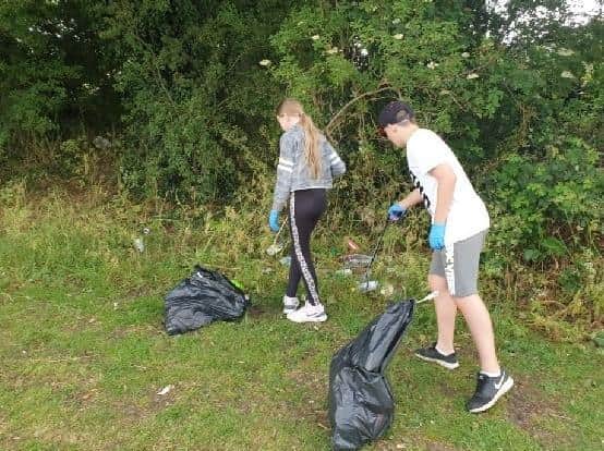 Louie and Ellie Barker help make our community cleaner.