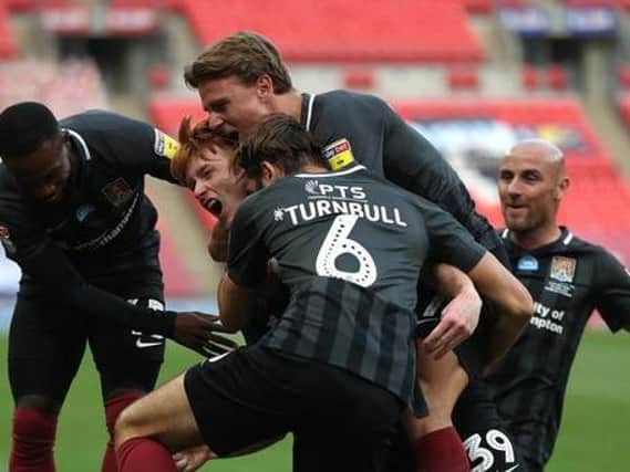 The Cobblers players were able to celebrate during the first half as Callum Morton gave them a 2-0 lead against Exeter City at Wembley