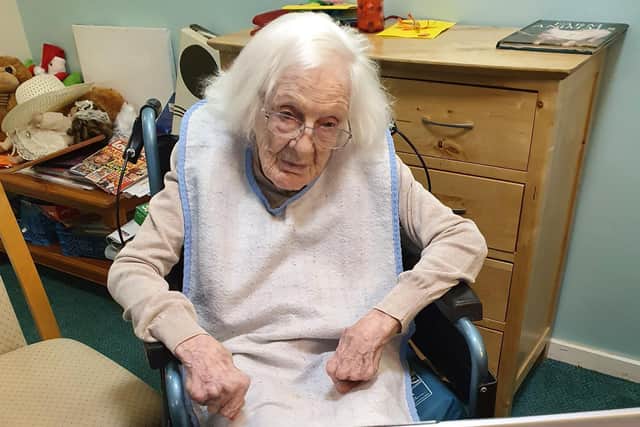 Joan Furniss in front of the laptop for her Zoom calls