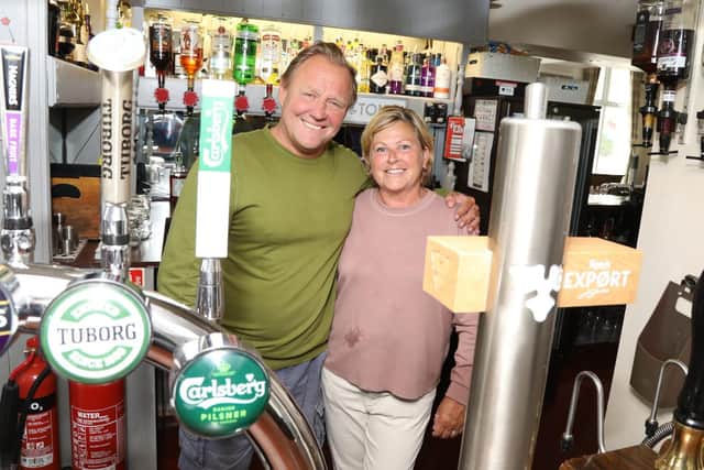 Mark and Helen Gee, back behind the bar of The Crown pub