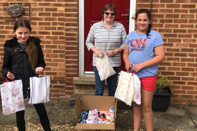 Maisy (left) and Jess deliver goody bags to Kettering ICU nurse Jo Lonsdale