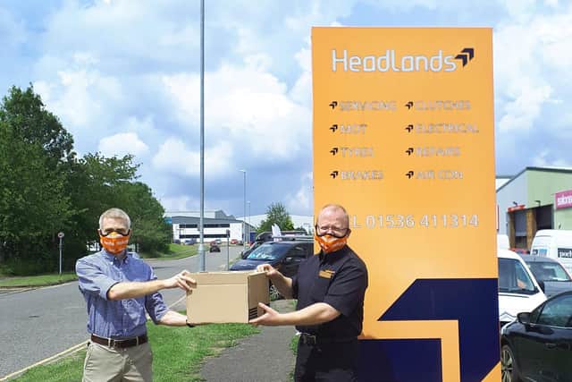 Dorothy Springer trustee Andy Brown, left, taking delivery of the face masks from Mike Deely, owner of Headlands Garage in Kettering.