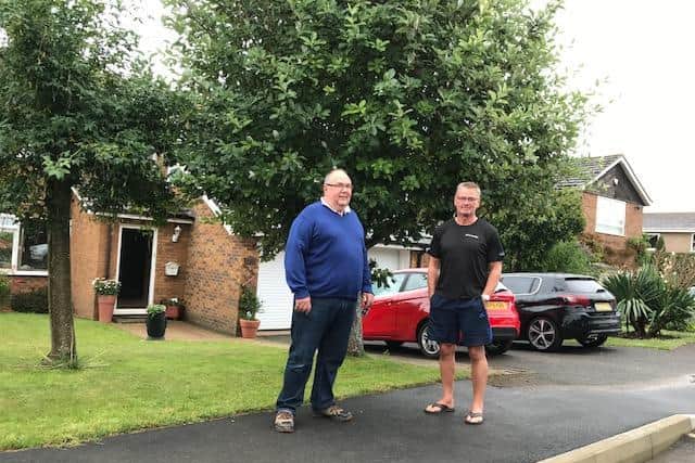 Cllr Hallam with Russ Spencer in front of his home.