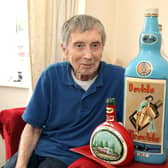 John Stock with some of his bottle art