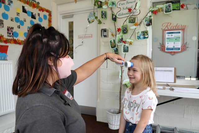 Penelope, 4, has her temperature taken by Christine Gilsenan