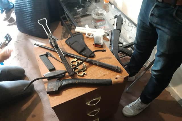 A crossbow, imitation firearms and a knuckleduster were also seized.