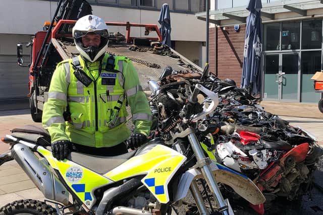Sergeant Lee Flavell with the crushed bikes