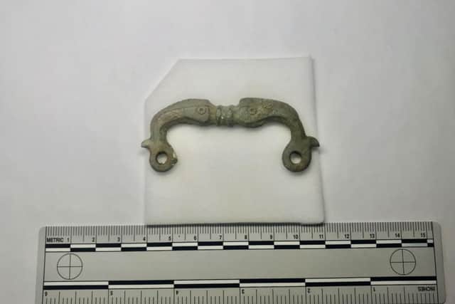 A complete zoomorphic buckle depicting two flanking dolphins