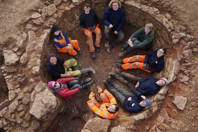 The Oxford Archaeology East team sat inside the lime kiln chamber