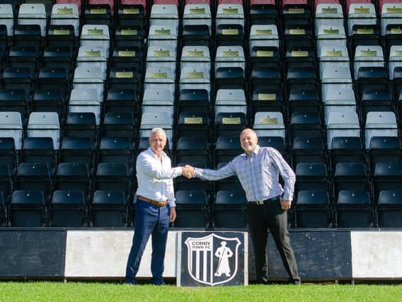 New Corby Town manager Gary Mills (left) and assistant Darron Gee shake on it after they arrived at Steel Park last weekend. Picture by Chelsea Aves-Darrah