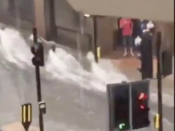 Water flooded through the town centre this afternoon after flash flooding