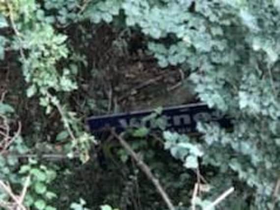 One of the signs dumped in the hedge. Picture: www.twitter.com/NorthantsSCIU