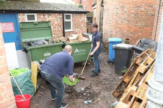 Rutherfords staff members tidy up the back yard