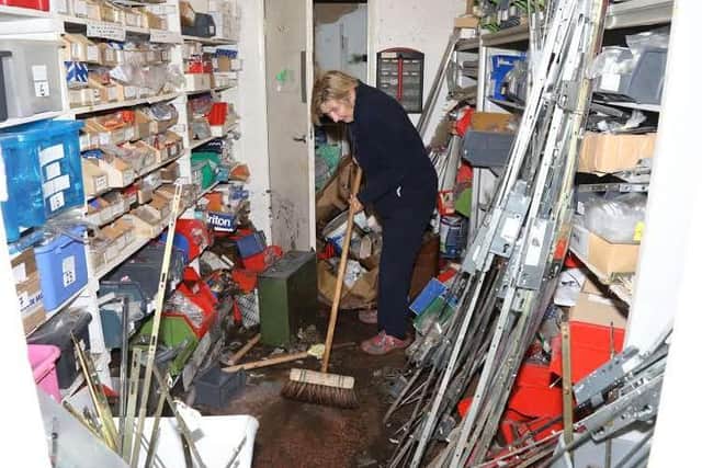 Val Wilson co-director of Rutherfords Locksmiths in Market Street clears up one of the store rooms