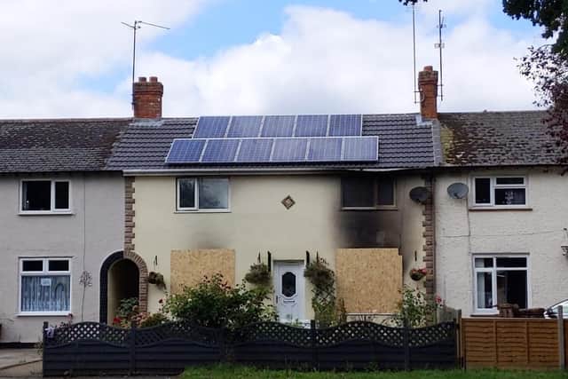 The Stamford Road house has been badly damaged by the fire. A woman has been arrested on suspicion of arson.
