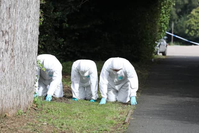 Forensics officers at the scene on Sunday.