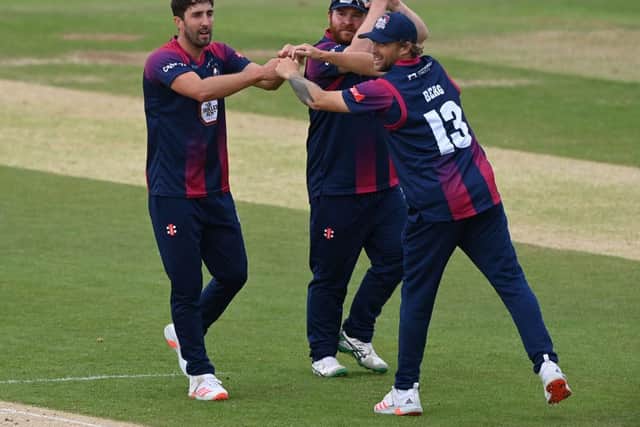 Ben Sanderson celebrates claiming one of his three wickets