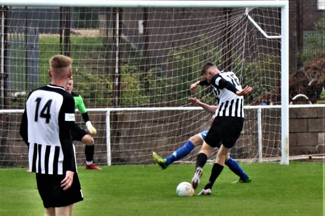 Elliot Sandy scores one of his four goals after coming on as a substitute in Corby's friendly win at Desborough