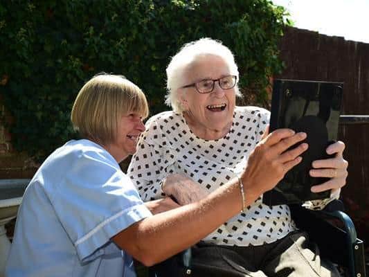 Monica, a resident at The Old Vicarage, using one of the Facebook Portals