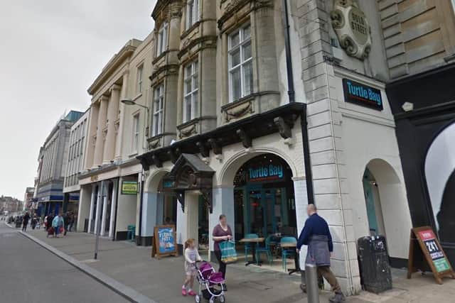 A dispute over a dropped tenner outside Turtle Bay is being treated as robbery by police