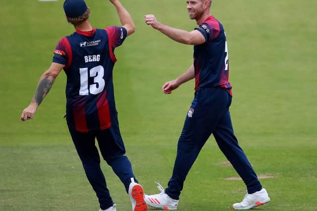 Luke Procter (right) celebrates after claiming the wicket of Ian Cockbain