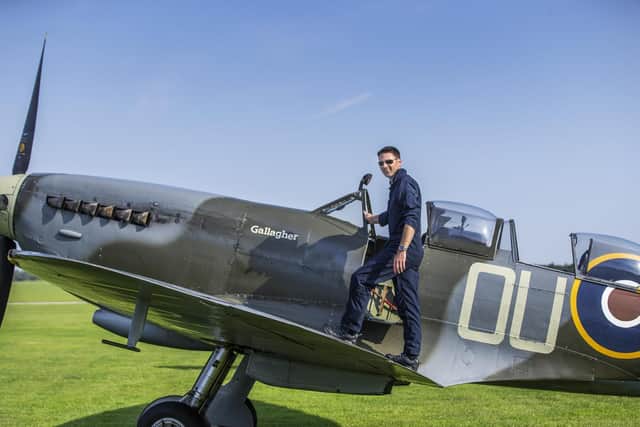 Spitfire pilot, Andy, pictured on the wings of his plane before joining in with the fly past this afternoon. Pictures by Kirsty Edmonds.