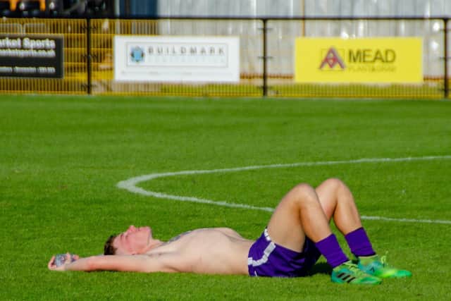Jordon Crawford lies on the ground after Corby Town’s penalty shoot-out defeat at Mildenhall Town in the FA Cup last weekend