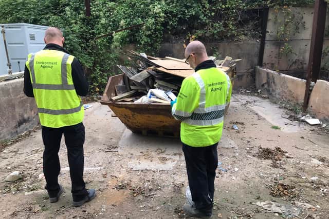 Environment Agency staff examine the waste