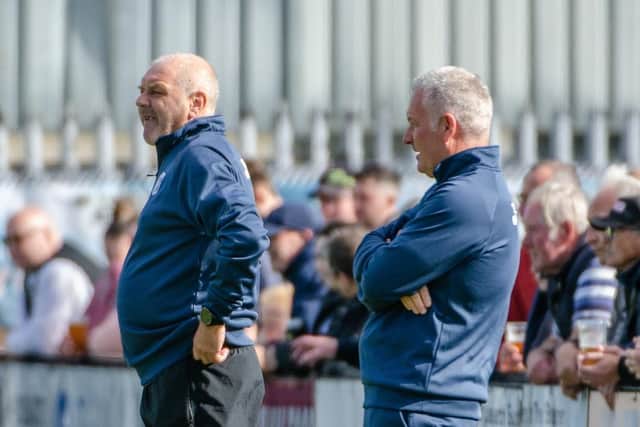 Gary Mills (right) and assistant-manager Darron Gee watch on from the sidelines