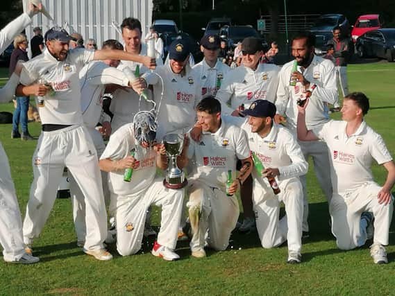 The Loddington & Mawsley players savour the moment after their one-wicket win over Stony Stratford in the Division One final