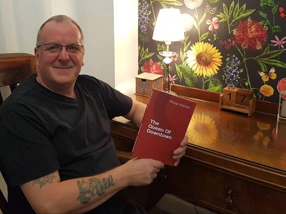 Philip Holmes with his debut novel, The Queen of Downtown, which is partially set in his hometown Wellingborough
