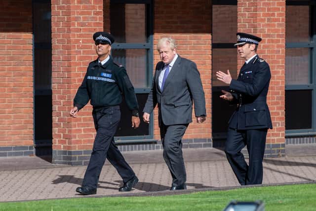 Boris Johnson managed to avoid the heavy rain as he was shown around Wootton Hall Park by Deputy Chief Constable Simon Nickless and PC Merb Hussain.