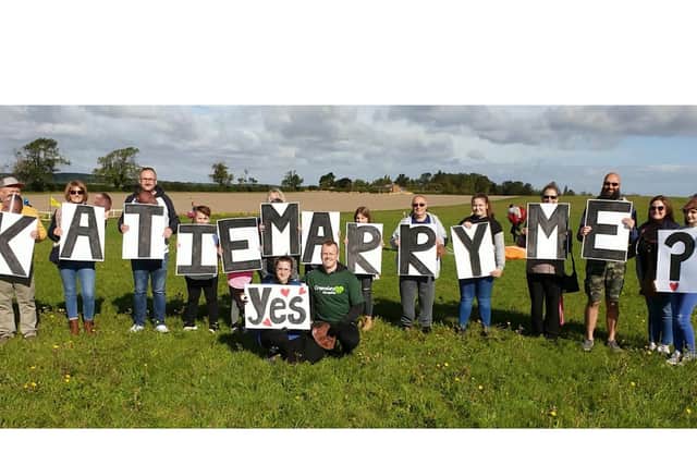 Katie Marry Me? was held on signs below the plane.