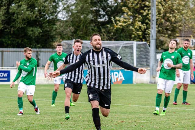 Steve Diggin heads off to celebrate after he scored his 100th goal for Corby Town in the 3-0 FA Trophy success at Soham Town Rangers. Pictures by Jim Darrah