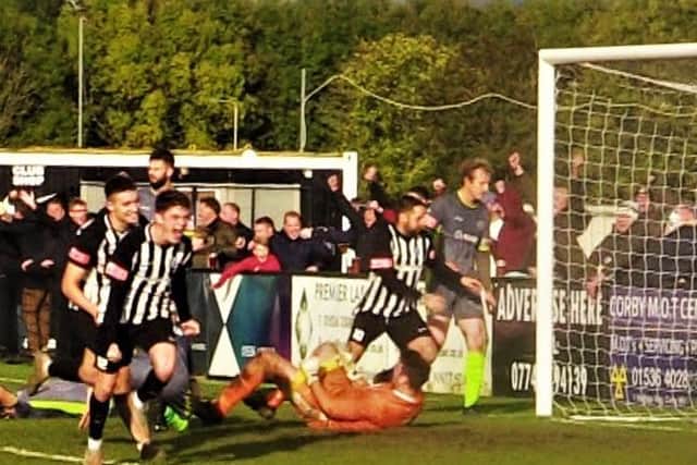 Connor Furey heads off to celebrate after he scored his first senior goal to complete Corby Town's famous comeback against Halesowen Town at the weekend. Picture by David Tilley