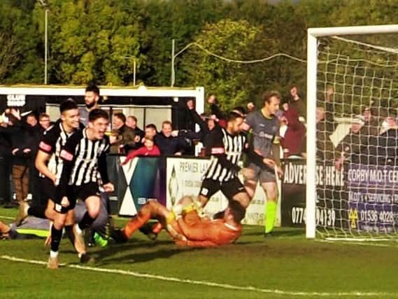 Connor Furey heads off to celebrate after he scored his first senior goal to complete Corby Town's famous comeback against Halesowen Town at the weekend. Picture by David Tilley