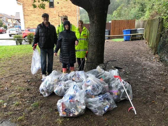 Kevin and Lesley Thurland and Greg and Josie Titcombe, along with some of the collected litter.