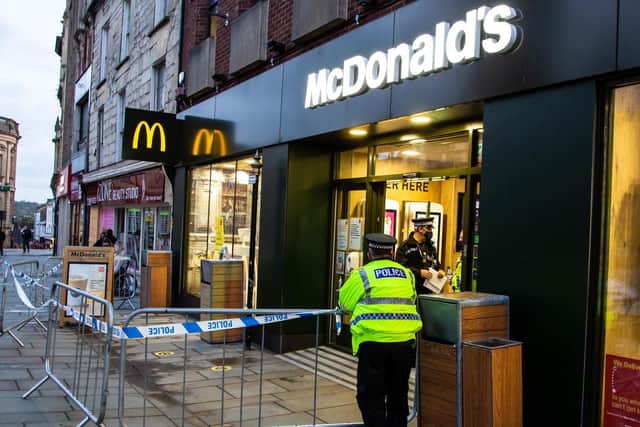 Police used barriers to block off the entrance to McDonald's