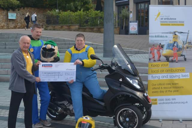 Helen presents the cheque.