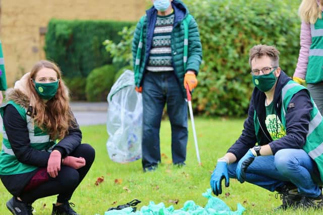 Emily Fedorowycz and Dez Dell with the dog poo they cleared.
