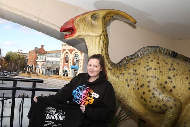 Duty manager Fran Richards with Jurassic Grill's merchandise.
