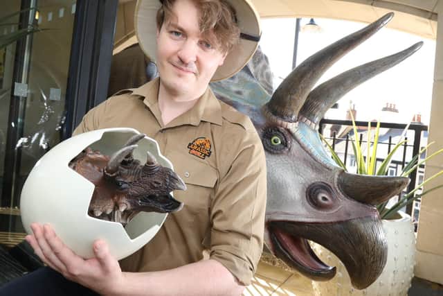 Curtis Ainge with the new baby triceratops.