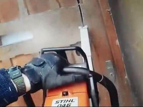 Armed officers used a chain saw to bust their way into a property during the 100-day crackdown on crime. Photo: Northamptonshire Police