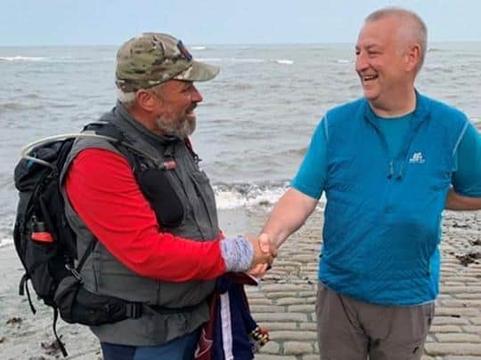 Matt Ellmer with his walking partner Andy Green at the end of their coast to coast walk in Robin Hood's Bay