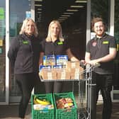 Staff at Hallwood Road Co-op with the lunchboxes available this half-term